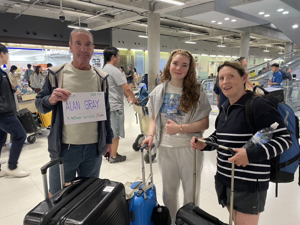 Customer at Don Mueang arrivals holding a name sign